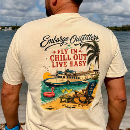 A man wearing a coastal theme Embargo Outfitters tshirt