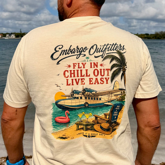 A man wearing a coastal theme Embargo Outfitters tshirt