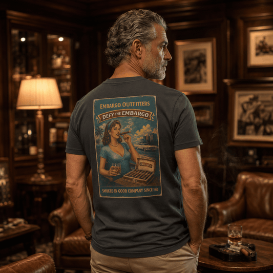 Man wearing an Embargo t-shirt with a graphic design in a cigar bar setting