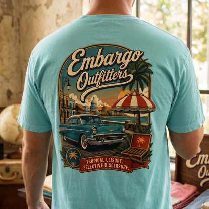Person wearing a light blue t-shirt with 'Embargo Outfitters' graphic design.